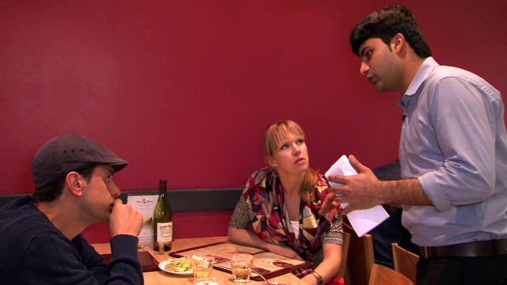 Waiter Wahaz makes menu recommendations for an Estonian couple in the Pakistani restaurant.